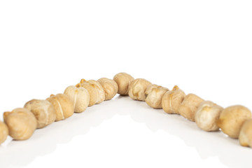 Lot of whole raw fresh tan chickpea isolated on white background