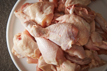 Fresh raw chicken legs on plate