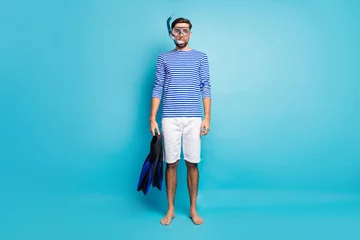 Fotobehang Full length photo of funny handsome guy tourist diving underwater mask breathing tube floating deep use flippers wear striped sailor shirt shorts isolated blue color background © deagreez