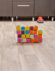 Fototapeta na wymiar children's colored cubes on the floor