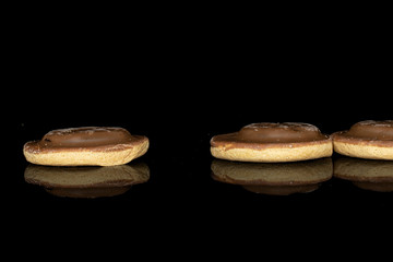 Group of three whole chocolate biscuit isolated on black glass