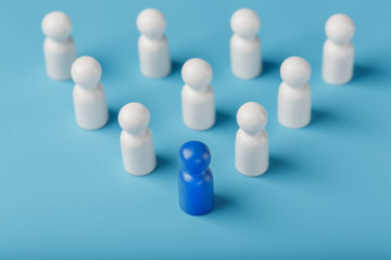 Blue leader the leader leads a group of employees in white to achieve the goal, personnel, and recruitment. The concept of leadership.