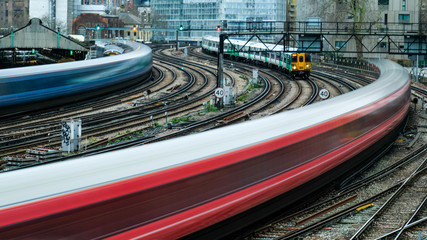 Motion blurred trains arriving on to railway station