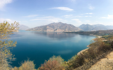 Fototapeta premium Beautiful panaorama view of blue water of the Chimgan Lake, Uzbekistan 