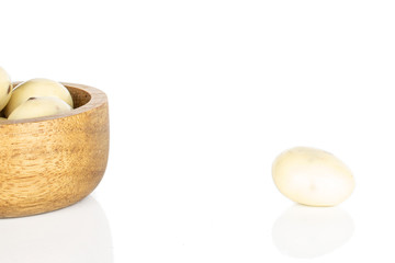 Group of four whole coated white almond nut stracciatella in bamboo bowl isolated on white background