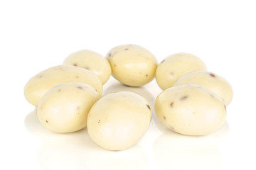 Group of eight whole coated white almond nut stracciatella isolated on white background