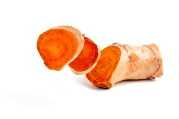 Cutting of turmeric curcumin root on isolated white background.