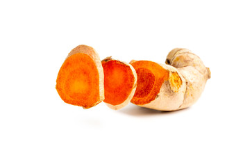 Cutting of turmeric curcumin root on isolated white background.