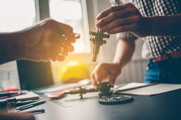 The mechanical engineering team is consulting the gear design.