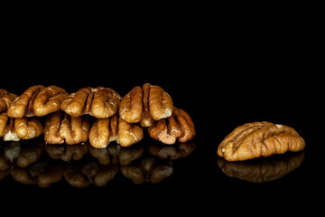 Lot of whole tasty brown pecan half isolated on black glass
