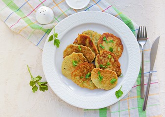 Traditional potato pancakes made from raw potatoes on a white plate on a light background concrete. Belorussian cuisine. Potato Recipes. Served with sour cream.