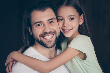 Closeup photo of beautiful little adorable lady and her handsome young daddy hugging dreamy toothy smiling spend weekend time homey domestic house room indoors