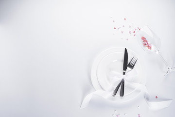 Sweet hearts with cutlery and white ribbon on a white background, with space for text. Valentine's...