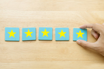 Hand giving five star rating or review;customer satisfaction survey