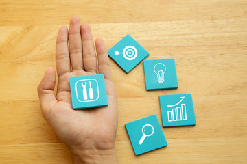 Hand with Business tools symbol