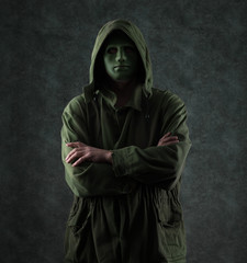 unknown green man in a hood on a green background