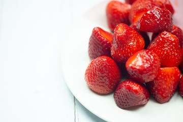 Fresh red strawberries in ceramic plate