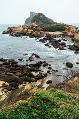 Fototapeta na wymiar Aerial view diversity of tourists walking in Yehliu Geopark, a cape on the north coast of Taiwan. A landscape of honeycomb and mushroom rocks eroded by the sea.