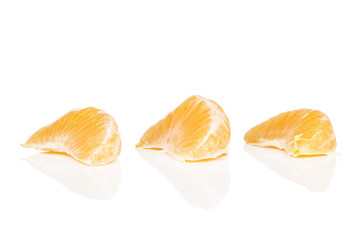 Group of three pieces of peeled fresh orange mandarin isolated on white background