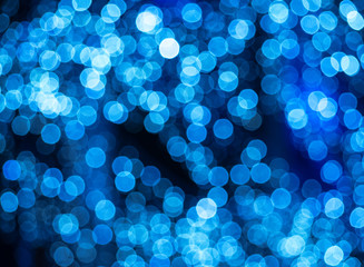 Blurry abstract pattern with blue light spots. Decorative background of defocused street bulbs