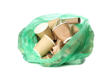 Green disposable bag with different trash isolated on white background