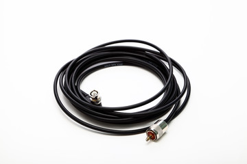 Coil of 50 ohm coaxial cable with a pl259 connector at one end and a BNC connector at the other end