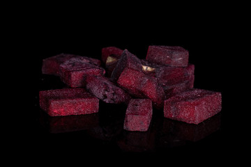 Lot of pieces of raw sweet beetroot isolated on black glass