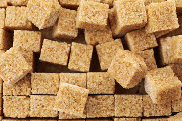 Brown sugar cubes texture background, close up