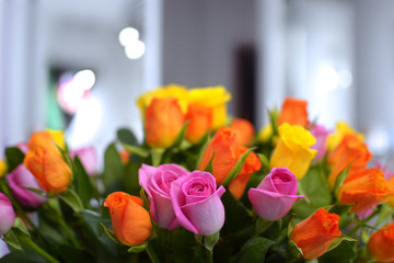 bunch of orange, pink and yellow roses