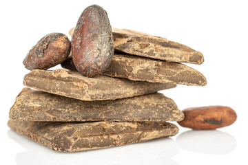 Three whole fresh brown cocoa beans with cocoa butter bars isolated on white background