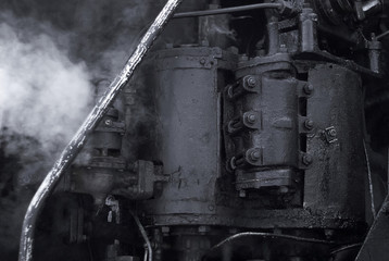 black background - fragment of a working vintage steam engine