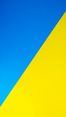 Yellow and blue color cardboard. Triangular shape of color cardboard.