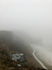 Breathtaking scenery at the Gullfoss Golden Waterfall landmark, a nature attraction in Iceland: Arctic nature with majestic rocks, the Hvita river running in the winter canyon with a cloudy white sky