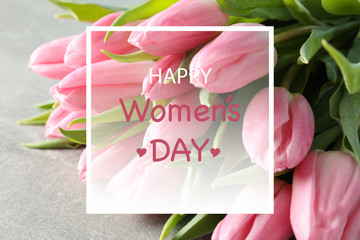 Inscription Happy Women's Day against grey background with tulips, close up