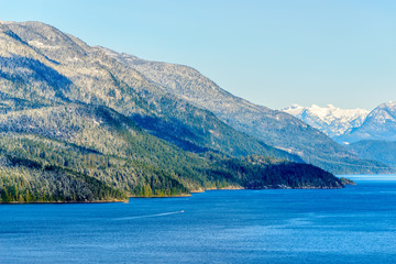 Fantastic view over ocean, snow mountain and rocks at Sechelt inlet in Vancouver, Canada.