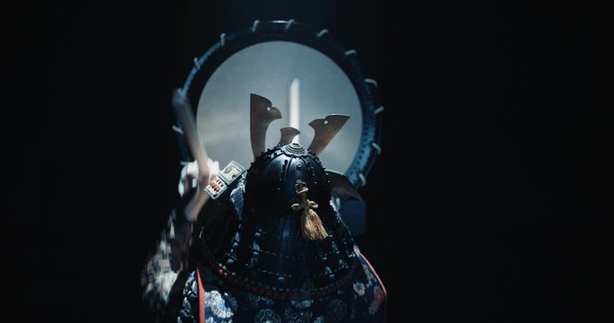Japanese man in historical samurai costume playing on taiko drum with kata moves, isolated on black background - culture, history concept 4k footage