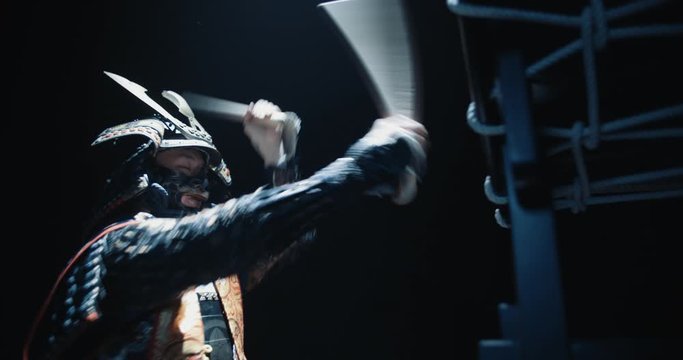 Asian man in historical samurai costume playing taiko drum, isolated on black background - tradition, history, culture concept close up 4k footage