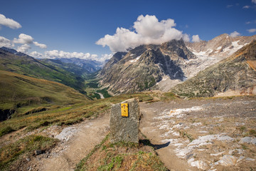 The summit of Grand Col Ferret and a view of the surrounding mountains of the European Alps
