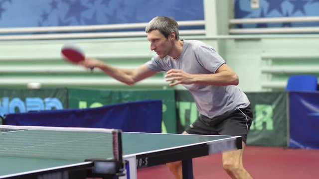 A man is swinging a racket at a ball