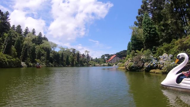 Hyperlapse of tourists at Lago Negro black lake park white swan and pirate ship pedal boat (pedalinho) - Gramado, Canela Rio Grande do Sul, Brazil