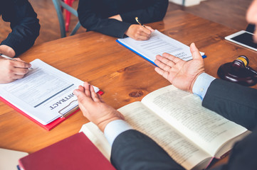 business people and lawyers discussing contract papers.Legal planning. Concepts of law, advice, legal services