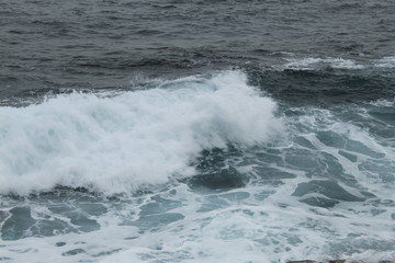 Fototapeta na wymiar CCliffs, waves and fog in Atlantic Ocean near A coruna.