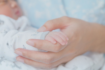 Closeup baby hand mother's hand