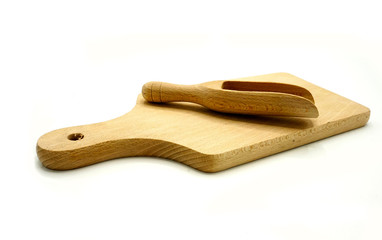 Wooden kitchen utensils on white background. Cutting board and scoop.