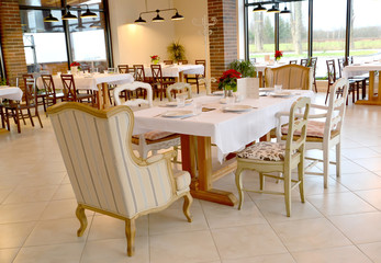 Served table and chairs in the restaurant room. Interior