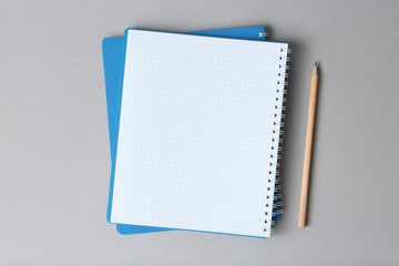 open notebook with pencil on a gray background