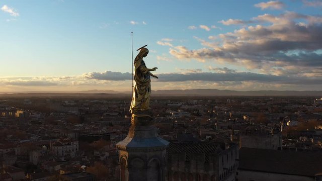 Golden statue of virgin Mary aerial shot Avignon Palace of the Popes famous Gothic building Europe morning sunrise