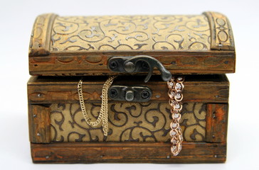 vintage wooden chest with gold decorations on white background