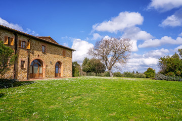 Fototapeta na wymiar Amazing spring landscape with typical old stone house in Tuscany, Italy