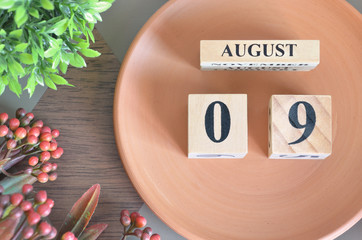August 9, month design with flower and earthenware.
